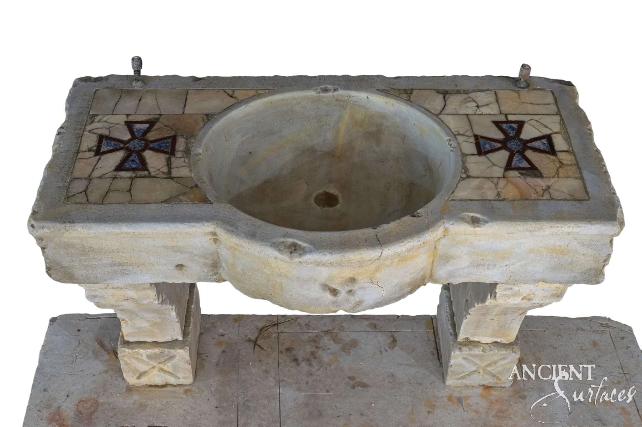 Hand-carved reclaimed limestone sink with a round basin and cross-motif pietra-dura mosaic inlay panels on a black background