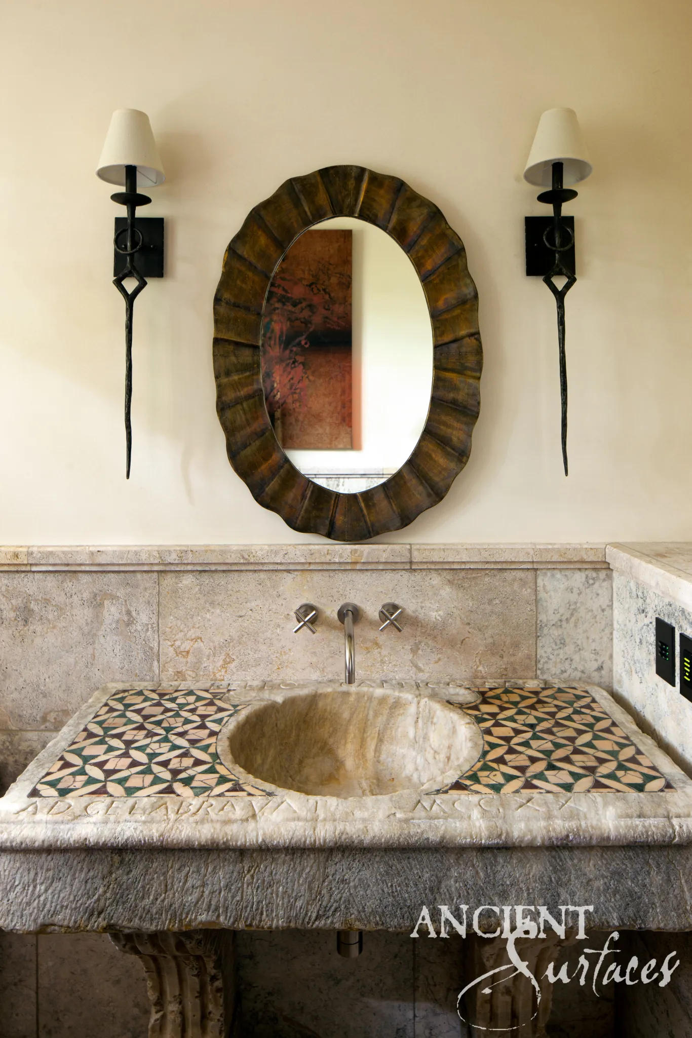 Reclaimed limestone sink with geometric star-mosaic panels and a carved Latin inscription on the apron
